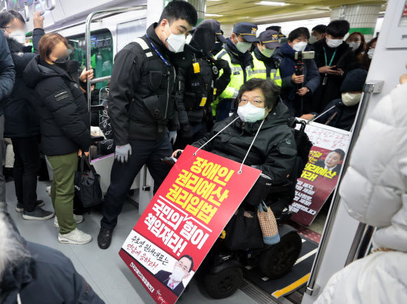 전국장애인차별철폐연대(전장연) 회원들이 20일 오전 서울 5호선 광화문역에서 지하철 탑승 시위를 벌이고 있다. 2022.12.20  연합뉴스