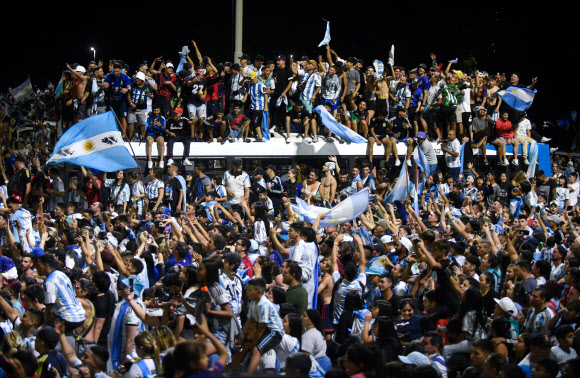 Soccer Football - Argentina team arrives to Buenos Aires after winning the World Cup - Buenos Aires, Argentina - December 20, 2022 Fans gather outside the Association of Argentinian Football Headquarters ahead of the Argentina team bus arrival. REUTERS 연합뉴스
