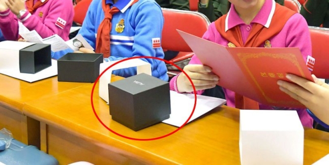 김정은이 조선소년단에 선물한 손목시계 상자 위에 일본 세이코의 패션 워치 브랜드 ‘ALBA’ 문구가 적혀져 있다. 조선중앙통신 연합뉴스 