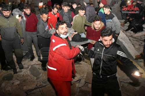 지진 여파가 미친 시리아 중부 도시 하마의 무너진 건물에서 부상자를 이송하는 구조대원들.  하마 로이터 연합뉴스