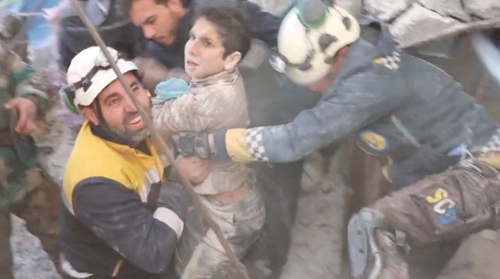 시리아 민방위대인 ‘화이트 헬멧’이 8일 잔다레스 지역에서 무너진 건물 잔해를 파헤쳐 소년을 구해내고 있다. 트위터 캡처