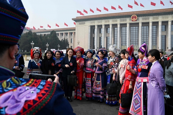 ‘시진핑 3기’가 공식 출범하는 중국 최대 정치 행사인 2023년 양회(전국인민대표대회·전국인민정치협상회의)가 시작된 가운데 5일 베이징 인민대회당에서 열린 전국인민대표대회 개막식에서 소수민족 대표들이 해외 언론 앞에서 기념 촬영을 하고 있다. 베이징 AFP 연합뉴스