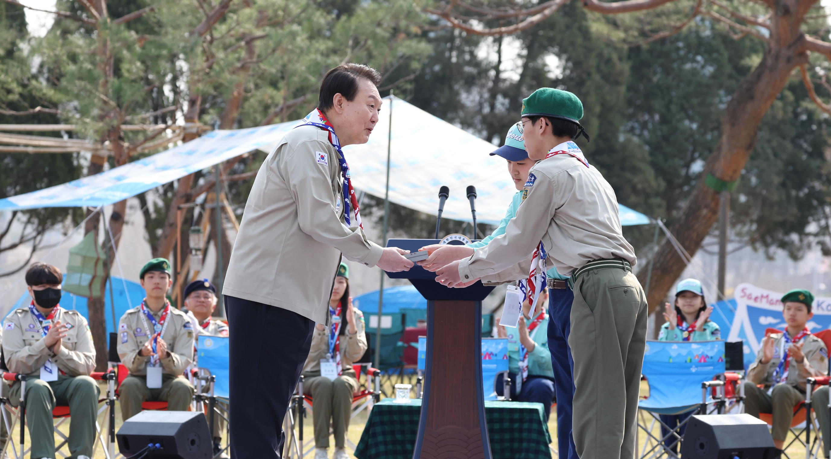 윤석열 대통령이 29일 오후 서울 용산 대통령실 청사 정원에서 열린 한국스카우트연맹 명예총재 추대식에서 명예총재 추대패를 전달받고 있다. 2023.3.29    연합뉴스