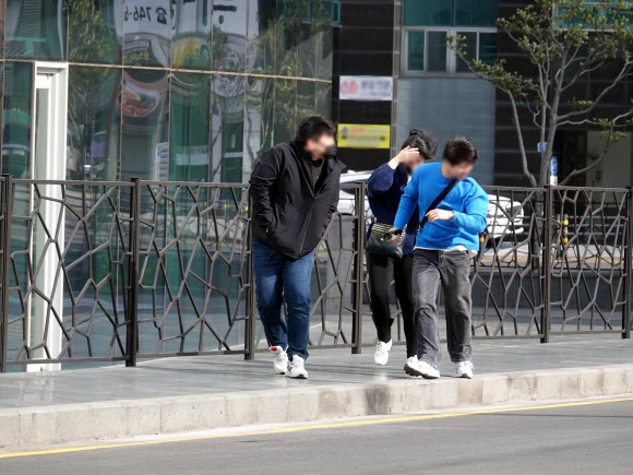 강풍경보가 내려진 18일 오전 제주시 한 도보에서 시민들이 바람을 헤치며 걷고있다. 이날 제주에서는 초속 27m의 강풍이 측정됐다. 2023. 04.18. 뉴시스