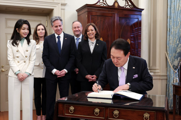 미국을 국빈 방문 중인 윤석열 대통령이 27일(현지시간) 워싱턴DC 미 국무부 본관 건물에 위치한 ‘벤자민 프랭클린 국빈연회장’에서 열린 국빈 오찬에서 카멀라 해리스 미국 부통령, 블링컨 국무장관 등이 지켜보는 가운데 방명록을 쓰고 있다. 2023.4.28. 공동취재