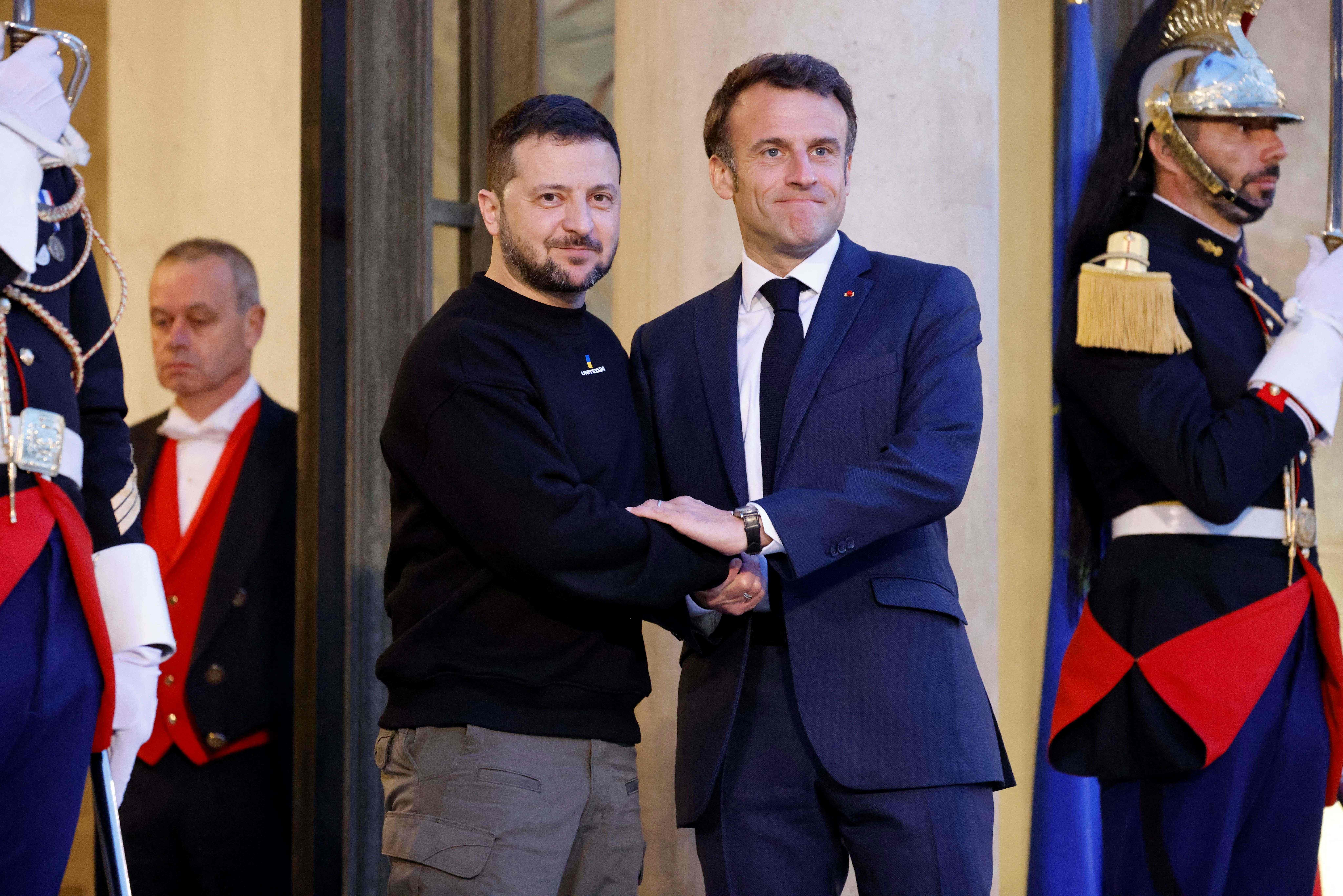 에마뉘엘 마크롱(오른쪽) 프랑스 대통령과 볼로디미르 젤렌스키 우크라이나 대통령이 14일(현지시간) 프랑스 파리 엘리제궁에서 손을 맞잡고 있다. 파리 AFP 연합뉴스