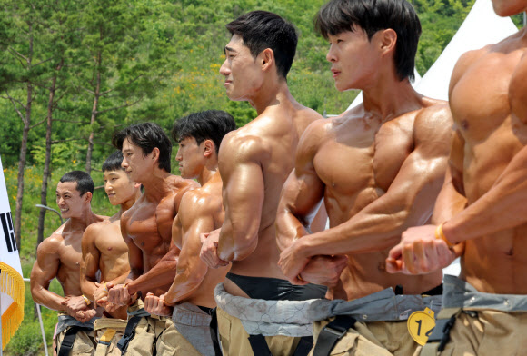 13일 충남 공주 사곡면 중앙소방학교에서 열린 제36회 전국소방기술경연대회에서 몸짱 소방관 부문에 참여한 소방관들이 멋진 근육을 선보이고 있다. 2023.6.13 연합뉴스