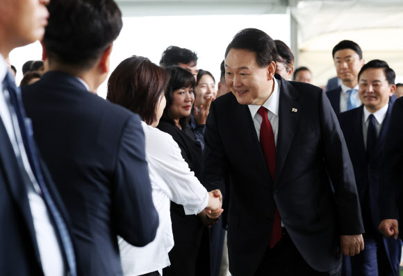 윤석열 대통령이 30일 경기 고양시 어울림누리 별무리경기장에서 열린 ‘서해선 대곡-소사 복선전철’ 개통 기념식에 입장하며 정의당 심상정 의원과 인사하고 있다. 2023.6.30 연합뉴스