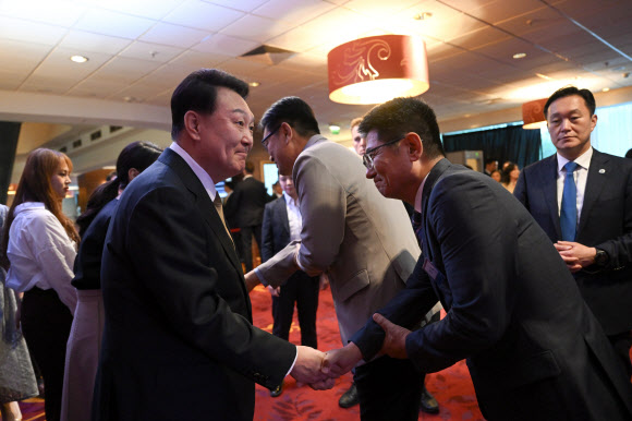 폴란드를 공식 방문한 윤석열 대통령이 12일(현지시간) 바르샤바 한 호텔에서 열린 동포간담회에서 참석자와 인사를 나누고 있다. 2023.7.13. 공동취재