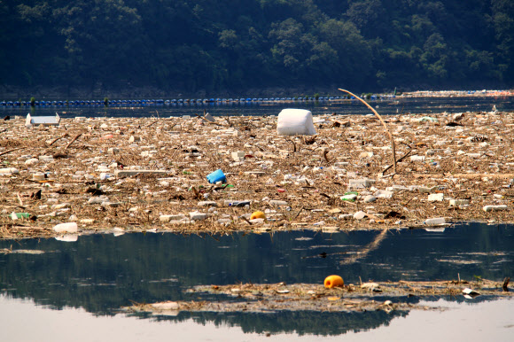 충북 옥천군 군북면 석호리 대청호에 장마 때 떠내려온 쓰레기가 거대한 섬을 이뤄 수면 위에 둥둥 떠 있다. 한국수자원공사 대청댐관리단은 쓰레기 수거에 2주일가량이 더 걸릴 것으로 전망했다.2023.7.31 연합뉴스