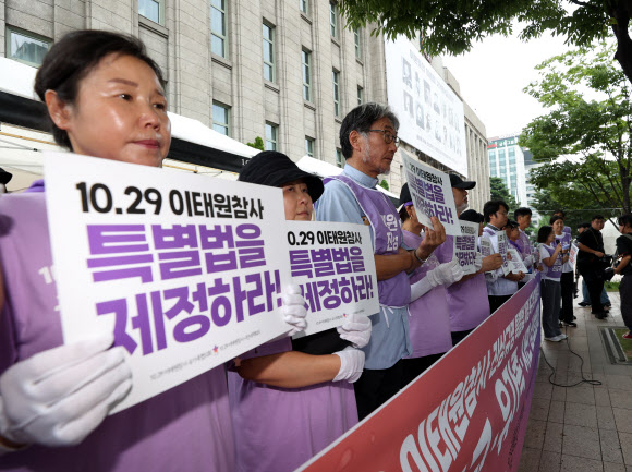 이태원 참사 발생 300일을 사흘 앞둔 22일 오전 중구 서울광장에서 열린 ‘이태원 참사 진상규명 특별법 제정 촉구 및 300일 추모 4대 종교 삼보일배’에서 유가족과 종교인들이 손팻말을 들고 있다. 2023.8.22 연합뉴스