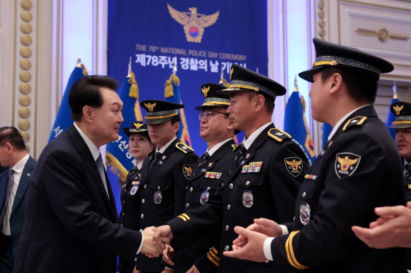 윤석열 대통령이 18일 청와대 영빈관에서 열린 제78주년 경찰의날 기념식에 입장하며 참석자들과 인사하고 있다. 2023.10.18. 대통령실 제공