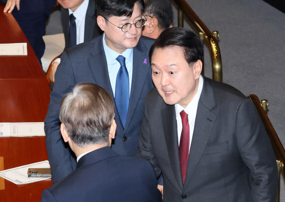 윤석열 대통령이 31일 내년도 정부 예산안에 대한 시정연설을 위해 국회 본회의장에 입장하며 더불어민주당 이재명 대표와 악수하고 있다. 2023.10.31  연합뉴스