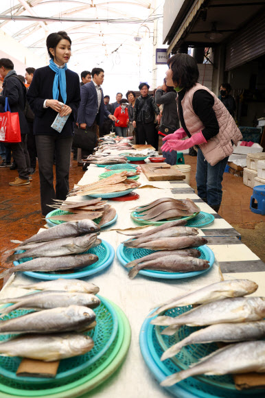 김건희 여사가 7일 전남 순천시 아랫장의 생선가게에서 반건조 생선 등을 구매하고 있다.   2023.11.7. 대통령실통신사진기자단