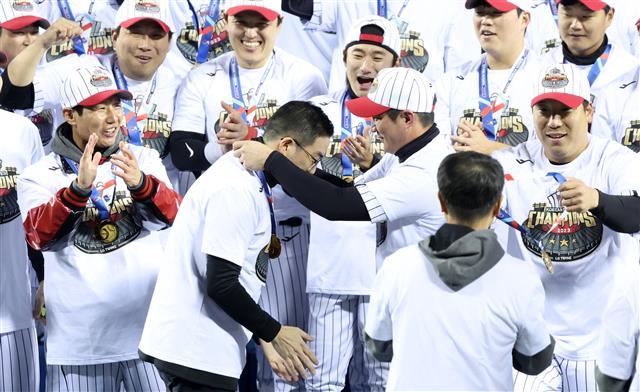13일 오후 서울 송파구 잠실야구장에서 열린 프로야구 ‘2023 신한은행 SOL KBO 포스트시즌’ 한국시리즈 5차전 LG 트윈스와 kt 위즈의 경기에서 6대2로 승리하며 우승을 차지한 LG 오지환이 구광모 LG그룹 회장에게 우승 메달을 건네고 있다. 2023.11.13 뉴스1