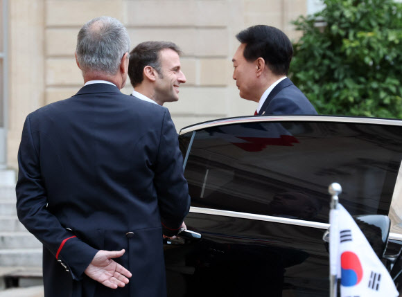 부산엑스포 유치활동을 위해 프랑스를 방문한 윤석열 대통령이 24일(현지시간) 파리 엘리제궁에서 한·프랑스 조찬 겸 정상회담을 앞두고 차에서 내리며 에마뉘엘 마크롱 대통령과 인사를 나누고 있다. 2023.11.24 연합뉴스