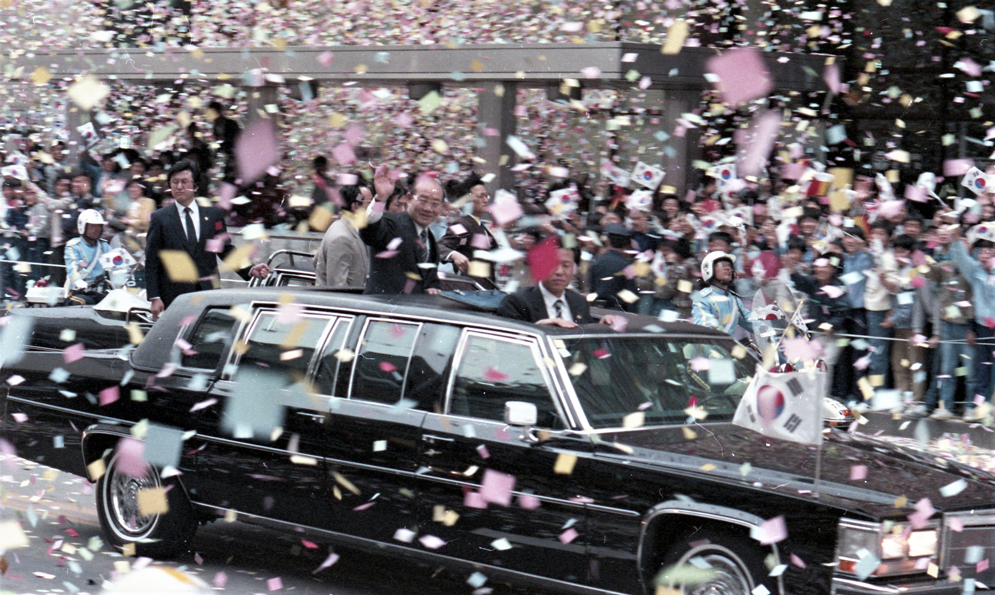 1986년 4월 21일 유럽순방을 마치고 귀국한 전두환 전 대통령이 시민들의 환영을 받으며 차량퍼레이드를 하고 있다. 1986. 4. 21 서울신문 사진창고