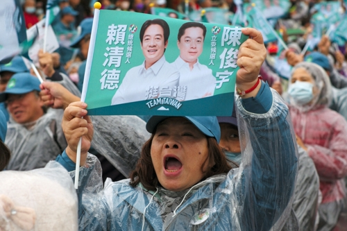 친미, 대만 독립 성향의 민진당을 지지하는 유권자가 21일 민진당 총통 및 부총통 후보 깃발을 흔들고 있다. 이란 AFP 연합뉴스