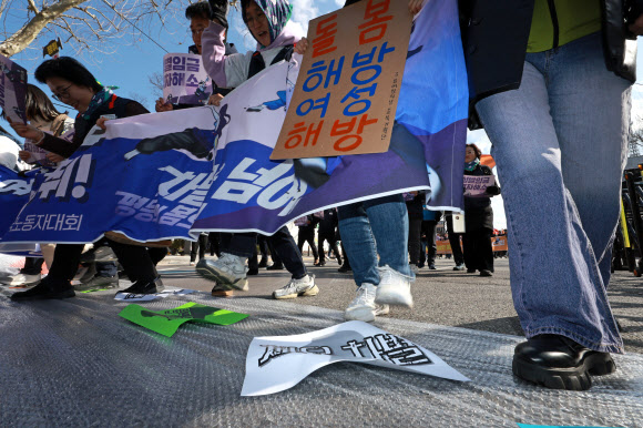 세계여성의 날인 8일 오후 민주노총 세계여성의날 정신 계승 전국노동자대회 참가자들이 서울 대학로에서 거리행진을 하며 에어캡 위에 적힌 각종 부정적인 단어들을 밟는 상징의식을 하고 있다. 2024.3.8 연합뉴스