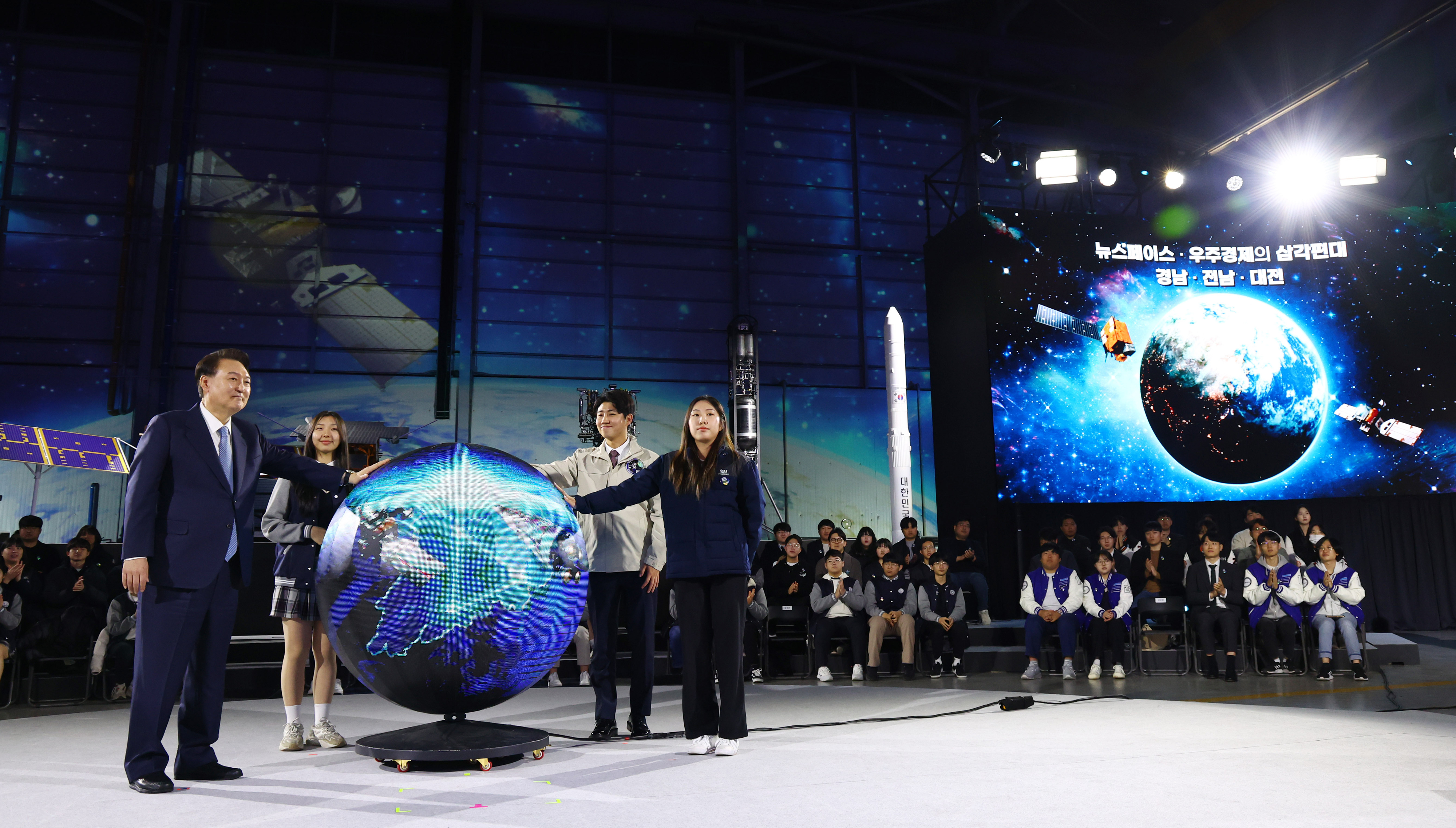 윤석열 대통령이 13일 경남 사천시 한국항공우주산업(KAI)에서 열린 ‘대한민국 우주산업 클러스터 출범식’에서 젊은 과학자들과 함께 무대에 올라 출범 기념 퍼포먼스를 하고 있다. 사천 뉴시스
