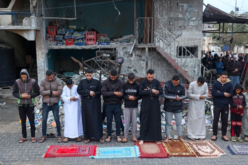 팔레스타인 주민들이 10일 이슬람 안식성월 라마단이 끝난 것을 기념하며 파괴된 모스크 바깥에서 기도를 올리고 있다. 라파 AFP 연합뉴스