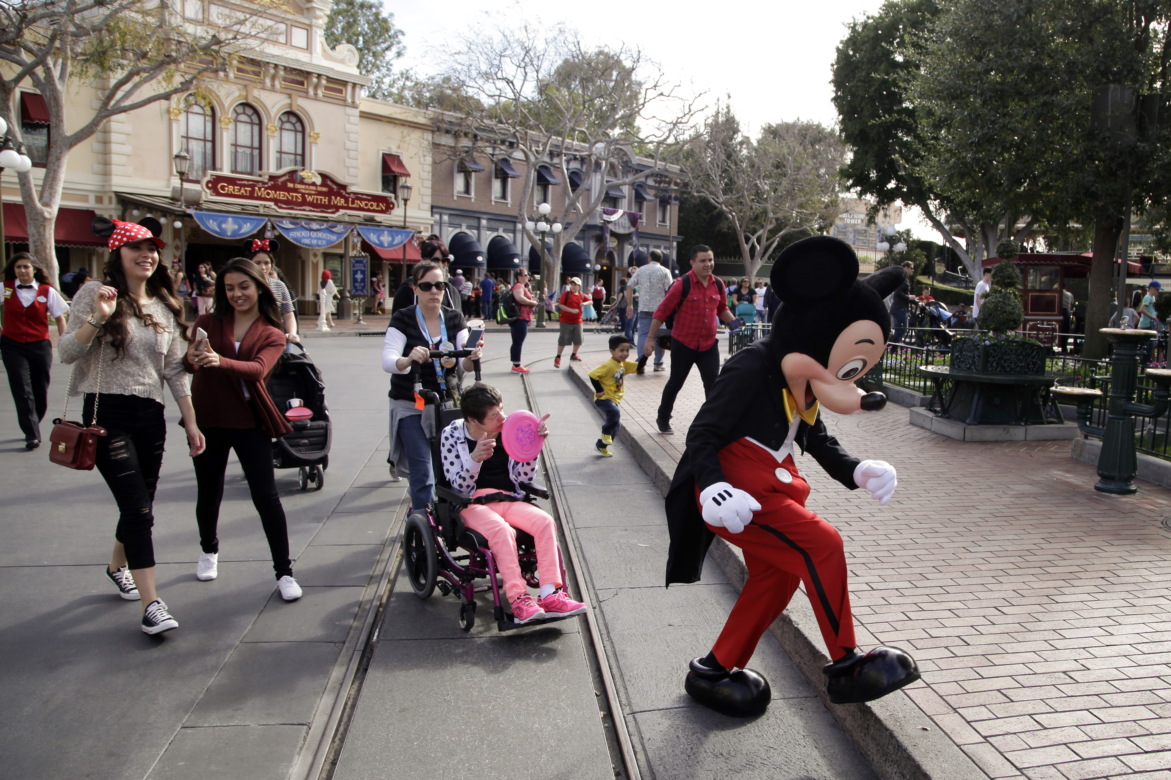 캘리포니아 디즈니랜드에서 미키마우스 탈을 쓴 직원이 관람객 앞을 걸어가고 있다. AP 연합뉴스