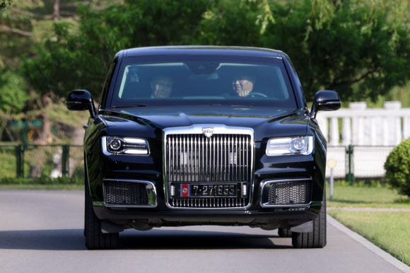 김 위원장이 19일 선물받은 러시아제 최고급 리무진 아우루스 조수석에 푸틴 대통령을 태우고 직접 운전해 숙소로 배웅하며 밀담을 나누고 있다. 평양 타스 연합뉴스