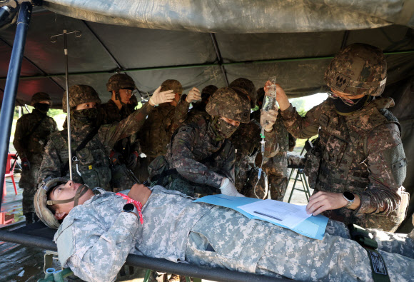 26일 강원 철원군 심일훈련장에서 열린 한미연합군사령부·합동참모본부·주한미군사령부 연합 의무지원 야외기동훈련(FTX)에서 육군 6사단 및 미 2사단, 한미연합사단 의무요원들이 부상자 응급처치를 실시하고 있다. 2024.6.26. 연합뉴스