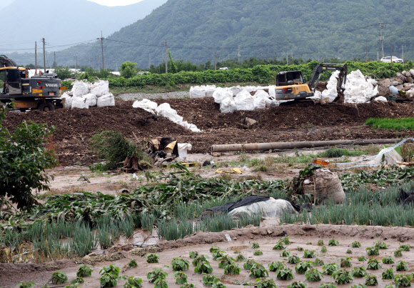 폭우가 지나간 이튿날인 11일, 수해 피해를 본 전북 완주군 운주면 엄목마을에서 무너진 제방을 복구하기 위해 중장비가 작업을 준비하고 있다. 2024.7.11  연합뉴스