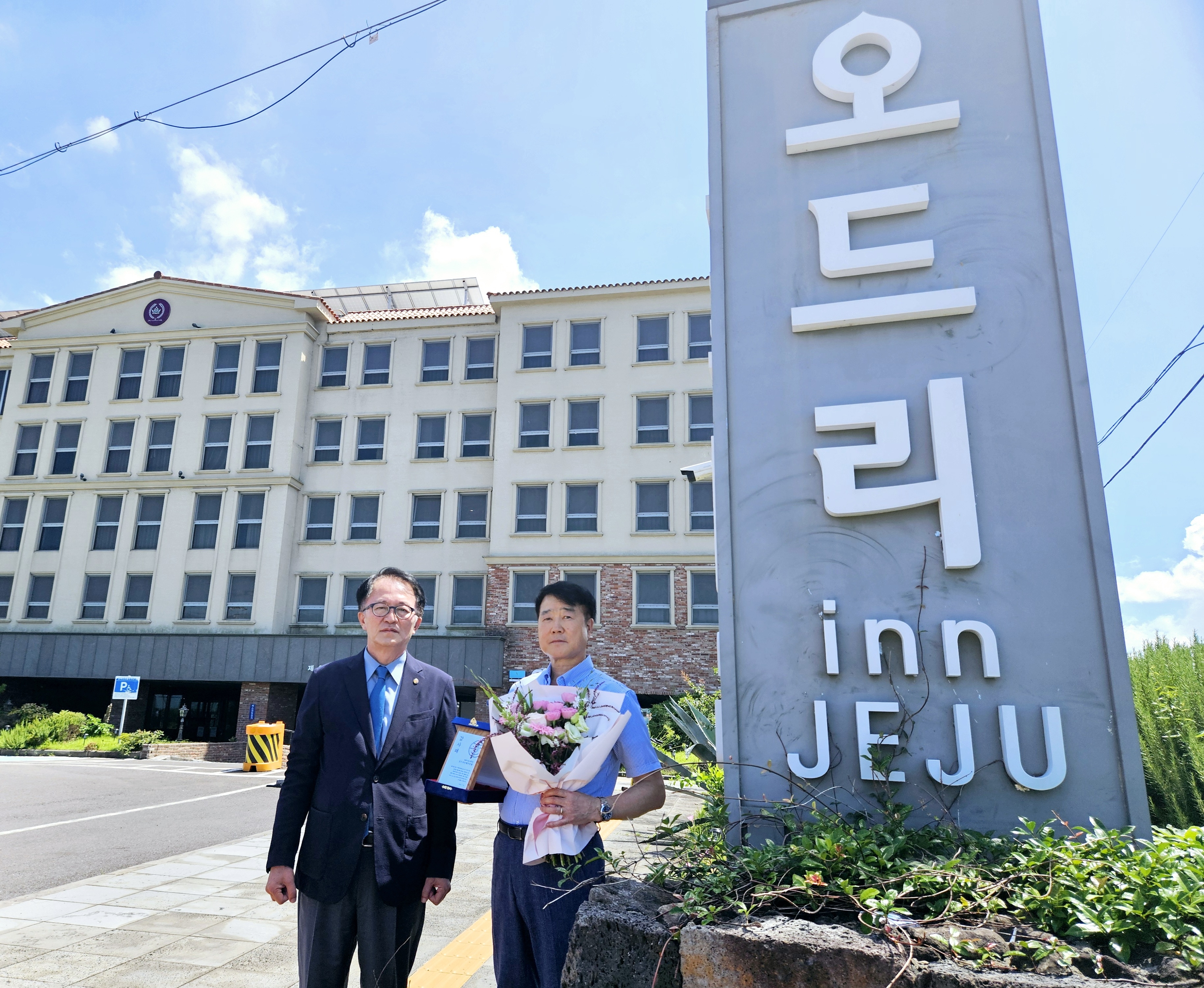 고승철 제주관광공사 사장이 31일 오드리 인 제주 호텔을 방문해 고득영 오드리 인 제주 총지배인에게 감사패와 꽃다발을 전달하고 기념촬영을 하고 있다. 제주관광공사 제공