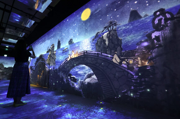 13일 오후 서울 중구 DDP에서 간송미술관 미디어 전시 ‘구름이 걷히니 달이 비치고 바람 부니 별이 빛난다’ 간담회 참석자가 전시를 둘러보고 있다. 2024.8.13. 연합뉴스