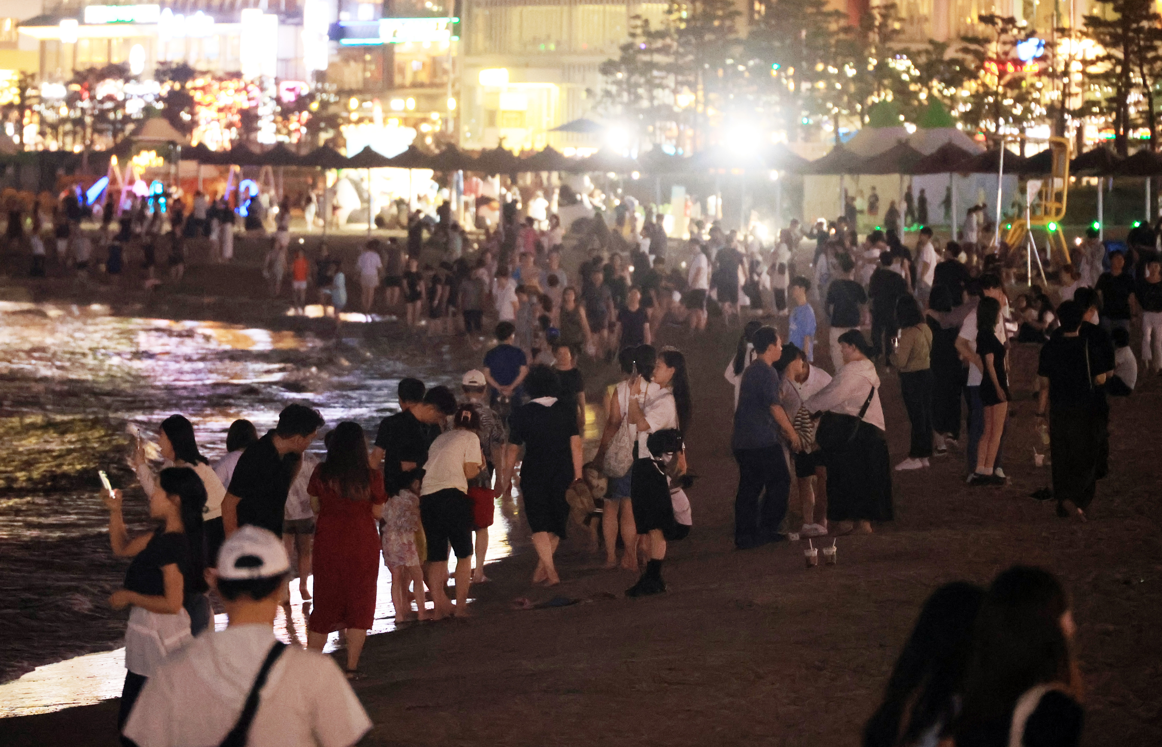 부산에 역대 최장인 21일 연속 열대야가 나타난 15일 오후 부산 수영구 광안리해수욕장에 많은 시민이 모여 바닷바람을 맞으며 더위를 이겨내고 있다. 부산 연합뉴스