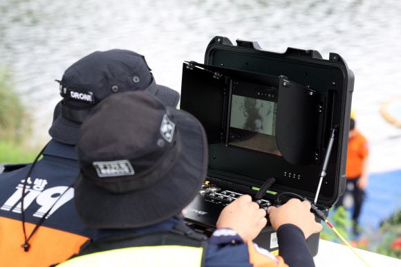 27일 오전 울산시 남구 태화강 십리대밭교 앞에서 열린 울산소방본부의 첨단소방장비 시연회에서 구조대원들이 수중로봇(ROV)을 활용해 물속을 수색하고 있다. 2024.8.27. 연합뉴스