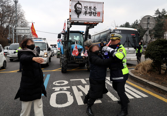 윤석열 대통령 구속 등을 촉구하며 트랙터를 몰고 상경한 전국농민회총연맹 전봉준 투쟁단이 21일 서울 서초구 남태령에서 경찰과 마찰을 빚고 있다. 2024.12.21  연합뉴스