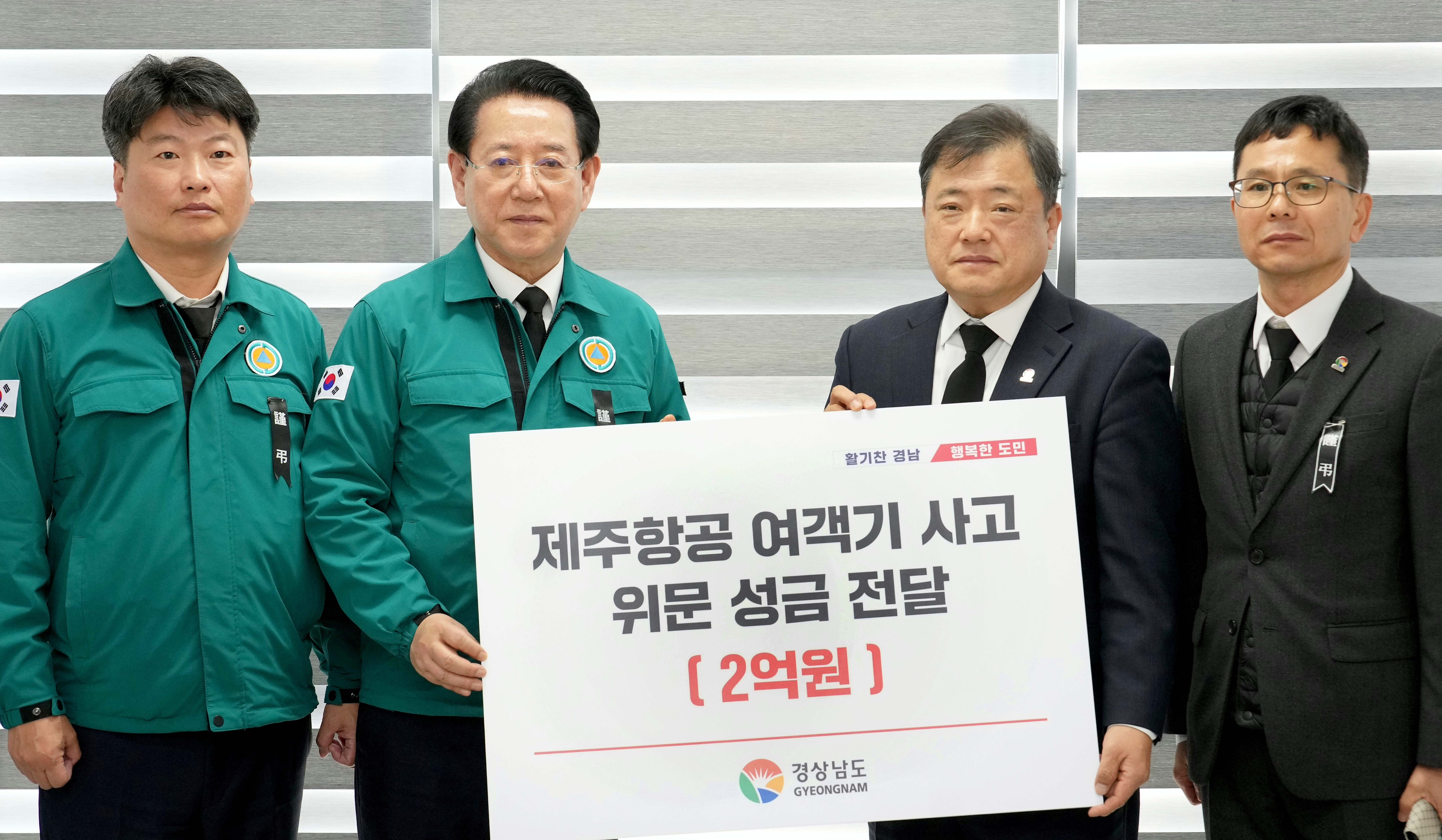 김영록 전남지사가 2일 무안공항에서 박명균 경상남도 행정부지사로부터 제주항공 여객기 사고 위로 성금을 전달받고 있다.