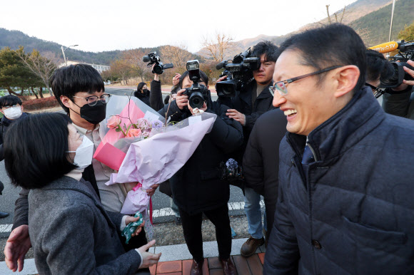 사건 발생 24년 만에 재심에서 무죄를 선고받은 김신혜 씨가 6일 전남 장흥군 용산면 장흥교도소에서 석방돼 꽃다발을 받고 있다. 김씨는 2000년 3월 아버지(당시 52세)에게 수면제를 탄 양주를 먹여 살해한 혐의로 기소돼 1심에서 무기징역을 선고받아 대법원 확정판결까지 받았으나, 2015년 재심 개시가 결정돼 이날 무죄를 선고받았다. 2025.1.6. 연합뉴스