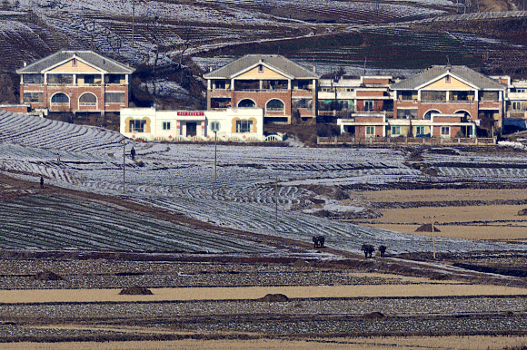 북한이 ‘신형 극초음속 중장거리 탄도미사일’ 시험발사에 성공했다고 주장한 7일 경기도 파주시 오두산 통일전망대에서 바라본 북한 황해북도 개풍군에서 주민들이 지게를 지고 이동하고 있다. 2025.1.7  연합뉴스