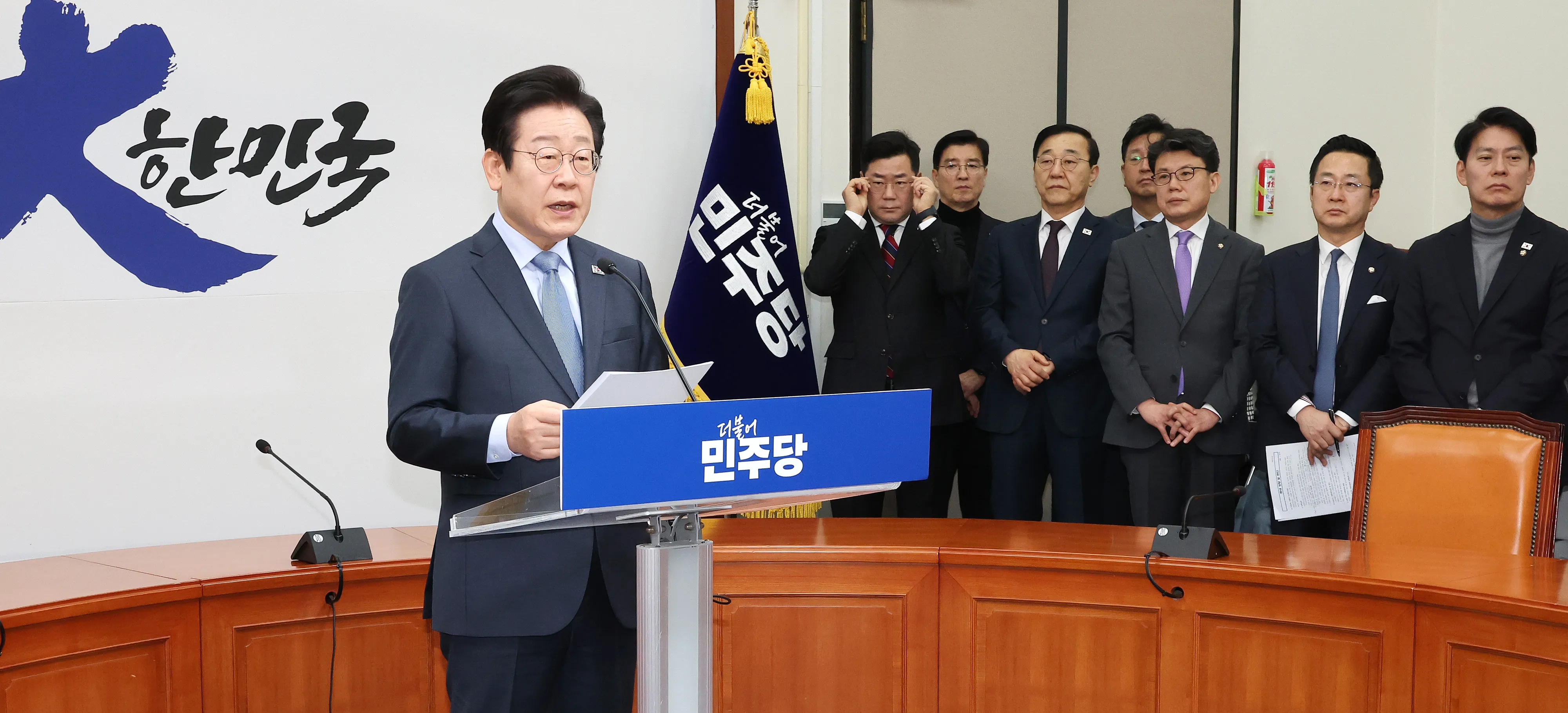 이재명 대표 “당 지지율, 국민의 뜻이니 겸허히 수용”  더불어민주당 이재명(왼쪽) 대표가 지난 23일 국회 당 대표 회의실에서 열린 신년 기자회견에서 발언하고 있는 가운데 당 지도부 인사들이 이를 지켜보고 있다. 2025.1.23