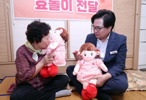 박일하(오른쪽) 서울 동작구청장이 어르신과 인공지능(AI) 돌봄로봇 효돌이를 살펴보고 있다. 동작구 제공