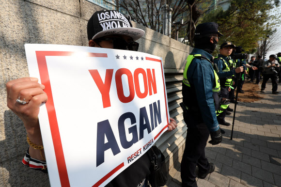 윤석열 전 대통령이 한남동 관저를 떠나 서초동 사저로 거처를 옮기는 것으로 알려진 11일 서울 서초구 사저 아크로비스타 인근에서 한 지지자가 손팻말을 들고 있다. 2025.4.11. 연합뉴스