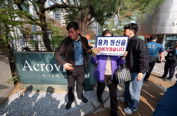 윤석열 전 대통령이 한남동 관저를 떠나 서초동 사저로 거처를 옮기는 것으로 알려진 11일 서울 서초구 사저 아크로비스타 인근에서 한 지지자가 손팻말을 들고 있다. 2025.4.11. 연합뉴스
