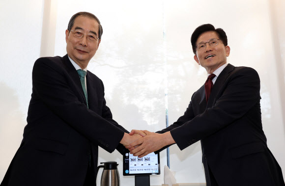 국민의힘 김문수 대선후보와 무소속 한덕수 대선 예비후보가 7일 서울 종로구의 한 식당에서 후보 단일화 관련 회동을 하기 전 악수하고 있다. 2025.5.7. 연합뉴스