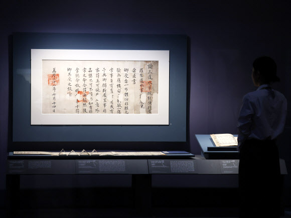 27일 서울 용산구 국립중앙박물관에서 열린 ‘우리들의 이순신’ 전시 언론공개회에서 참석자가 보물 ‘사부유서’를 둘러보고 있다. 충무공 탄신 480주년과 광복 80주년을 맞아 선보이는 전시는 다음 달 4일까지는 무료 개방한다. 2025.11.27   연합뉴스