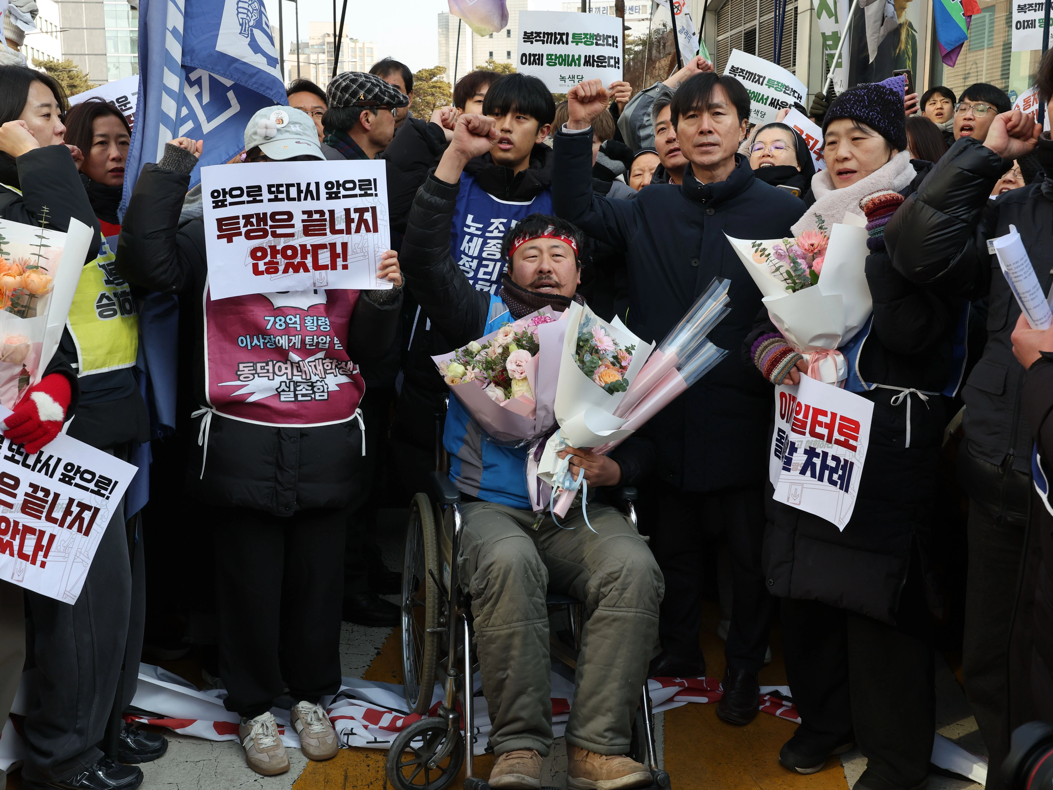 고진수 민주노총 서비스연맹 관광레저산업노조 세종호텔지부장이 14일 서울 중구 세종호텔 앞 구조물에서 내려온 뒤 휠체어에 앉아 구호를 외치고 있다.
연합뉴스