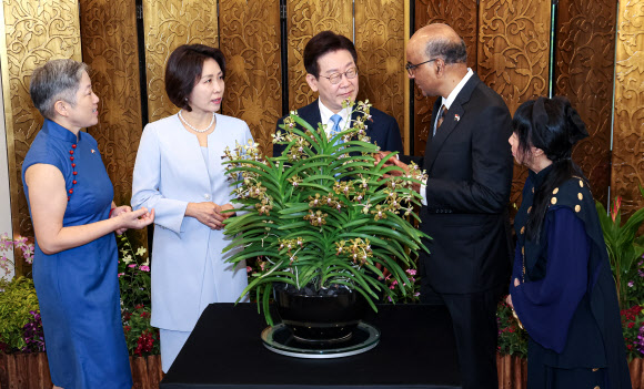 싱가포르를 국빈방문한 이재명 대통령과 김혜경 여사가 2일 싱가포르 외교부 청사에서 공식 환영식 후 타르만 샨무가라트남 싱가포르 대통령, 제인 이토기 샨무가라트남 여사와 난초명명식을 하고 있다.  난초 명명식은 새롭게 배양한 난초 종(種)에 귀빈의 이름을 붙이는 행사로, 난초를 국화로 삼는 싱가포르의 독특한 외교 관례다. 2026.3.2 연합뉴스