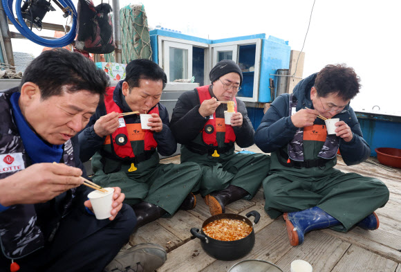 더불어민주당 정청래 대표와 인천시장 후보인 박찬대 의원이 11일 인천 강화군 서검도 앞바다 조업한계선 근처 괴리어장에서 새우잡이 조업 현장 체험을 하며 간식을 먹고 있다. 2026.3.11 [공동취재] 연합뉴스