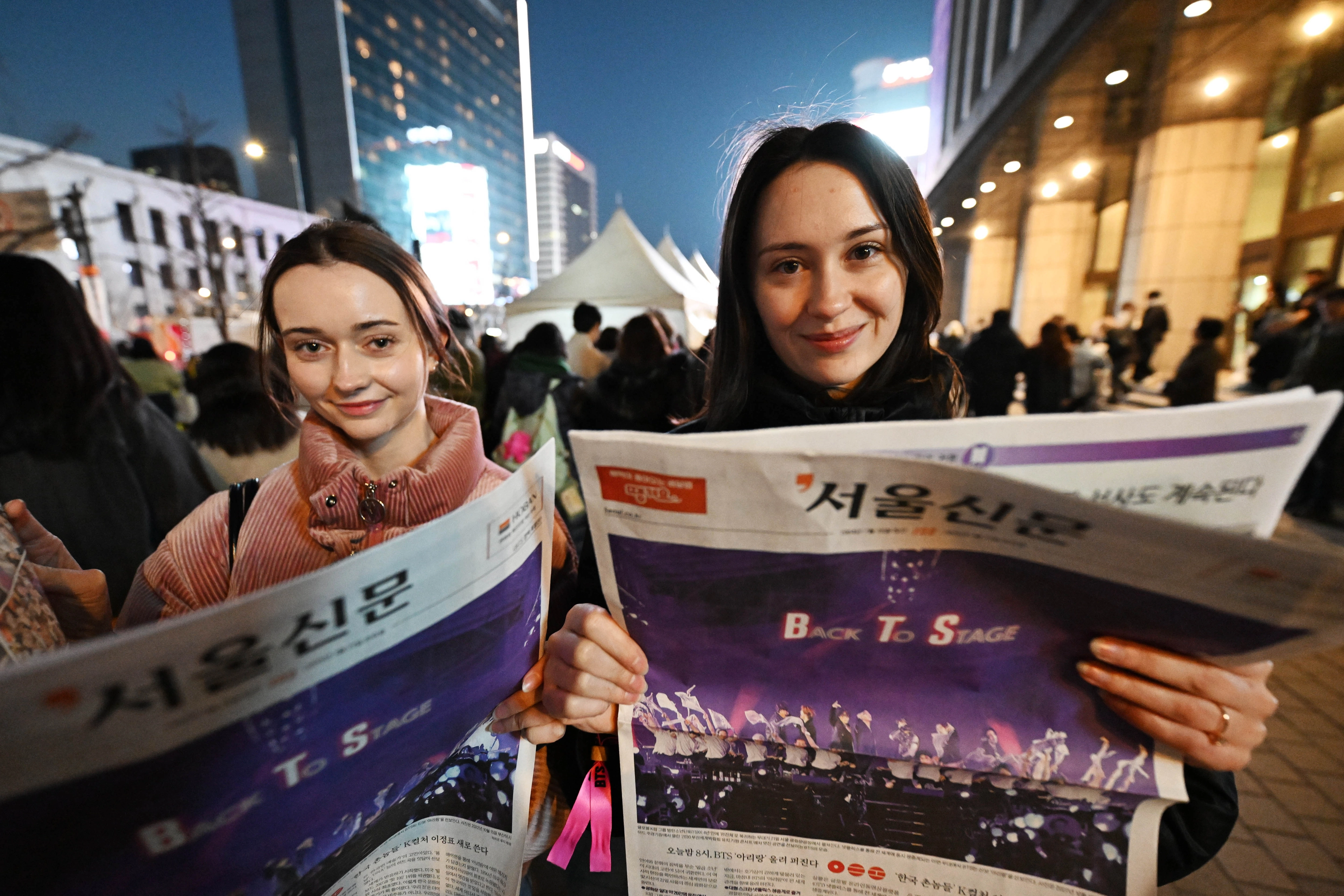 방탄소년단(BTS) 컴백 공연일인 21일 서울시청 광장에서 외국인 팬들이 호외로 제작된 서울신문 BTS 특별판을 살펴보고 있다. 2026.3.21 홍윤기 기자