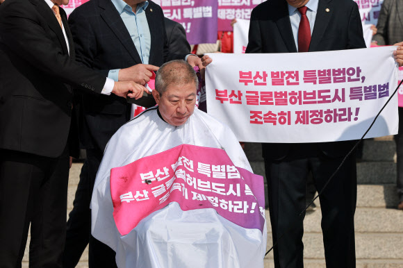 박형준 부산시장이 23일 국회 본청 앞 계단에서 부산 글로벌 허브도시 특별법 제정을 촉구하며 삭발하고 있다. 2026.3.23 연합뉴스