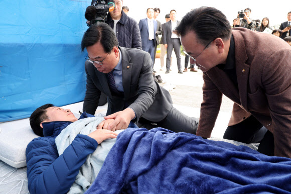 국민의힘 송언석 원내대표와 유상범 원내운영수석부대표가 22일 국회 본청 앞에서 단식 12일 차를 맞은 안호영 의원의 천막 농성장을 찾아 대화하고 있다. 2026.4.22 [공동취재] 연합뉴스