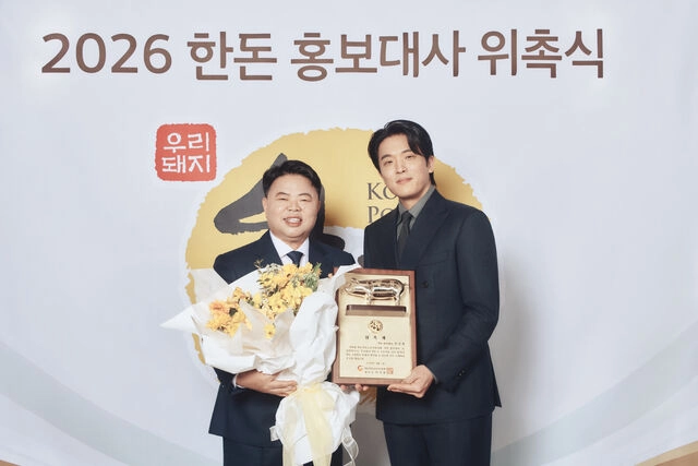 한돈자조금관리위원회는 안성재 셰프를 ‘2026 한돈 홍보대사’로 위촉하고 본격적인 홍보 캠페인에 돌입한다고 지난달 2일 밝혔다. 사진은 한돈 홍보대사 위촉식에서 이기홍(왼쪽) 한돈자조금관리위원장과 안 셰프가 위촉패를 들어 보이는 모습. 한돈자조금관리위원회 제공